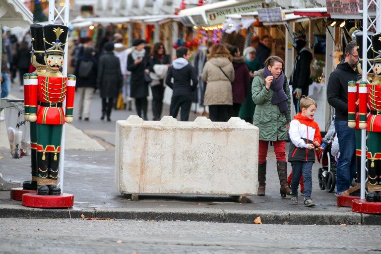 FRANCE, Paris: A concrete block is seen at one of the entries of the Champs Elysees Christmas market in Paris on December 24, 2016 after security measures were increased following the Berlin attack. - Michel STOUPAK