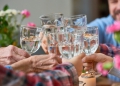 Close-up of united family clinking glasses of water together