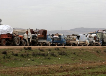 FILE PHOTO: A general view of vehicles carrying belongings of internally displaced Syrians from western Aleppo countryside, in Hazano near Idlib, Syria, February 11, 2020. REUTERS/Khalil Ashawi - RC2HYE9DKC59/File Photo