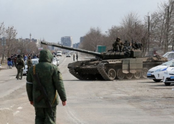 Service members of pro-Russian troops are seen atop of a tank during Ukraine-Russia conflict on the outskirts of the besieged southern port city of Mariupol, Ukraine March 20, 2022. REUTERS/Alexander Ermochenko