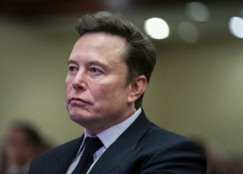 Elon Musk listens as President-elect Donald Trump speaks during a meeting with the House GOP conference, Wednesday, Nov. 13, 2024, in Washington. (Allison Robbert/Pool via AP)